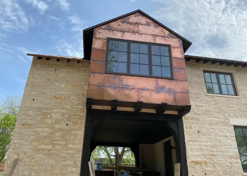 Copper metal panel facade on a stone building for Skylight Installation in Mesquite