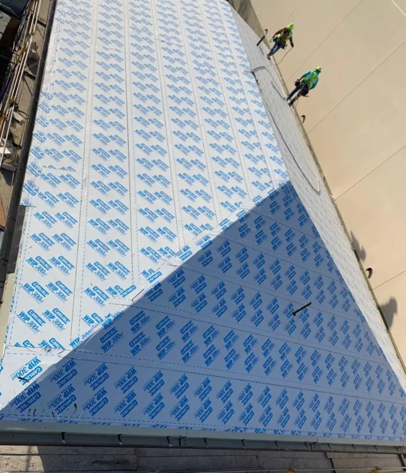 Professional roofers installing underlayment on a metal roof in Mesquite